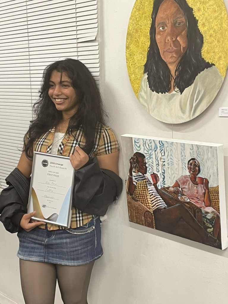 Eva posing in front of her artwork which saw her named the overall winner.